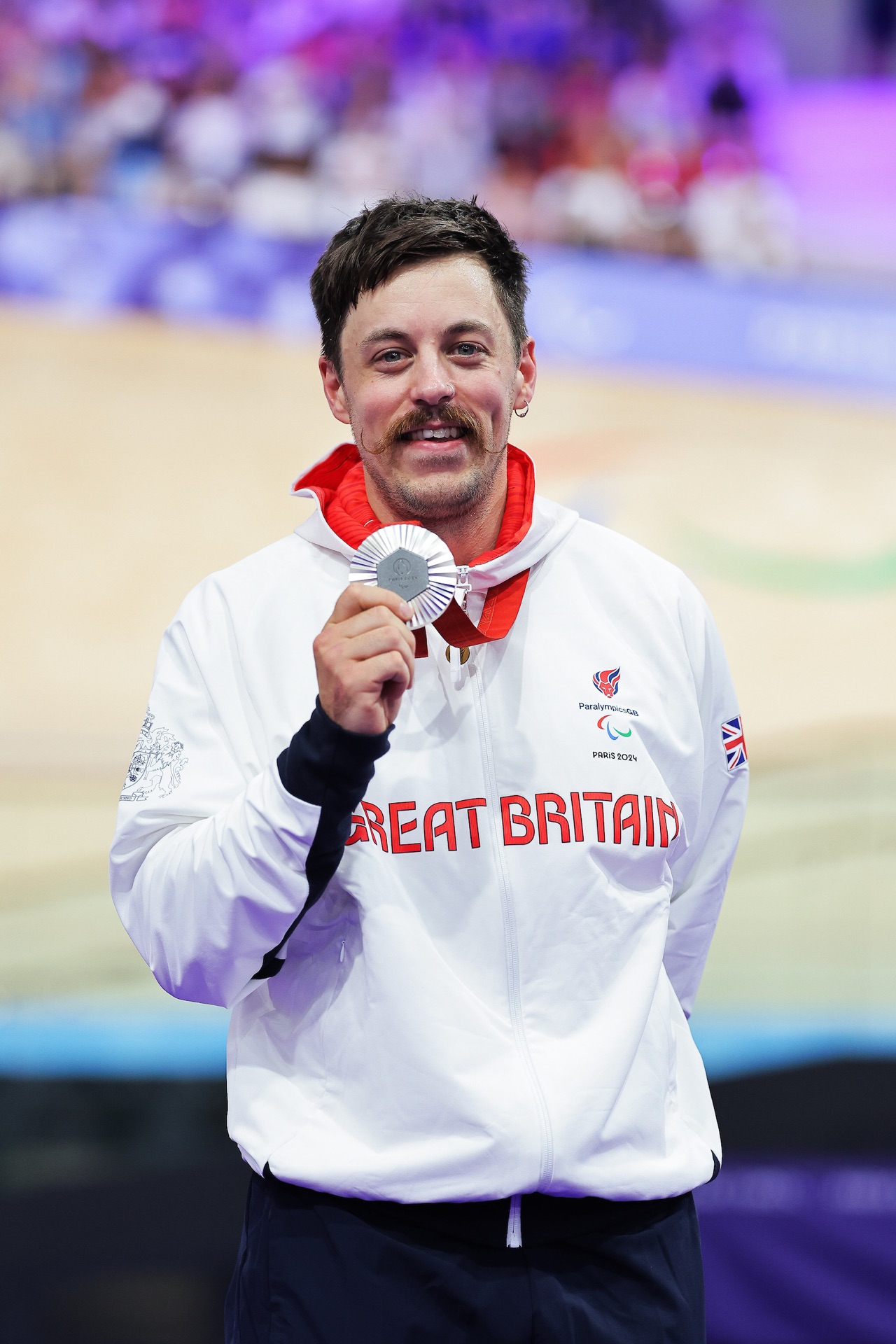 Blaine Hunt holding his Paralympic silver medal